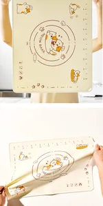 Detail of non-stick silicone baking mat with cute orange cat print and measurement scales