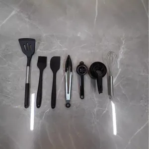 7-piece black silicone and stainless steel kitchen utensil set with whisk and spatula