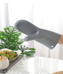 Detailed view of a grey heat-resistant silicone oven mitt showing non-slip textured palm