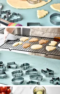 Professional action shot of stainless steel Christmas cookie cutters on blue pastry mat