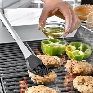 16-inch stainless steel BBQ oil brush with heat-resistant silicone bristles on grill
