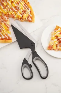 Detailed macro view of black stainless steel pizza scissors with spatula cutting a pizza