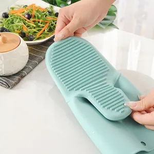 Green heat resistant silicone oven mitt with non-slip grip ridges for kitchen baking