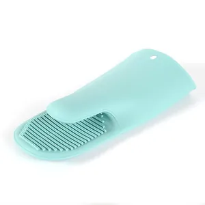 Heat-resistant mint green silicone oven mitt with anti-slip texture for kitchen baking.