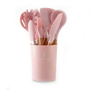 11-piece pink silicone kitchen utensil set with natural wooden handles and bucket.