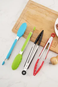 Juego de cuatro pinzas de cocina coloridas de acero inoxidable y silicona en una tabla