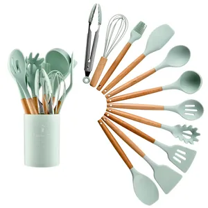 Overview of 11-piece mint green silicone kitchen utensils with wooden handles