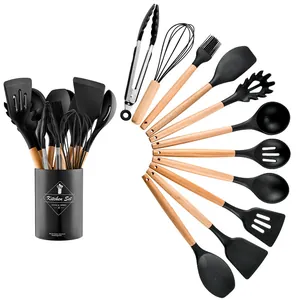 11-piece black silicone kitchen utensil set with natural wooden handles and storage bucket