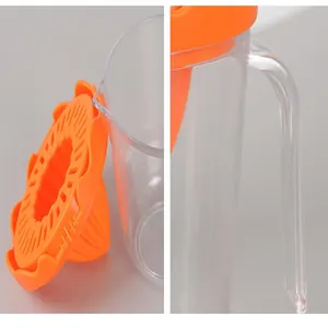 Detail view of portable manual fruit juicer cup with orange squeezer lid and handle
