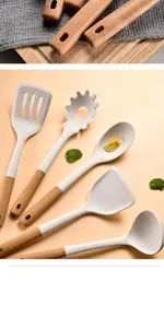 Close-up of cream silicone kitchen utensils with ergonomic wooden handles