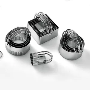 Professional stainless steel cookie cutter set with various shapes and handles for baking.