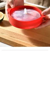 Detail shot of a red silicone collapsible popcorn bowl with a translucent cloud lid