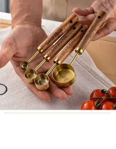 Close-up of gold-plated stainless steel measuring spoons with walnut wood handles