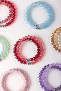 Detailed view of various natural crystal beaded bracelets in multiple vibrant colors