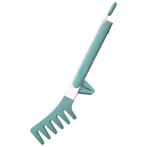 Mint green silicone and stainless steel comb-shaped pasta tong with built-in stand.