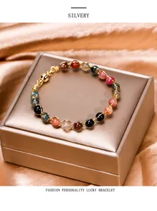 Detailed view of colorful tourmaline magnetic lucky bracelet with gold wrapping