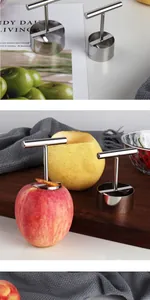 Stainless steel apple corer tool shown in use on red apple and wooden board