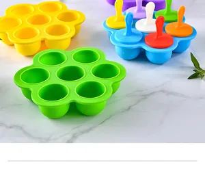 Detail macro view of 7-hole colorful silicone popsicle molds on white marble surface