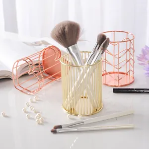 Elegant golden and rose gold metal wire desktop organizers for makeup brushes or pens.