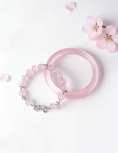 Pink rose quartz beaded bracelet with silver bow charm and matching bangle jewelry set.