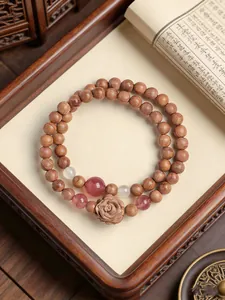 Detailed view of cedar wood rose bracelet featuring strawberry quartz and white agate beads