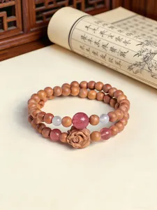 Detailed view of cedarwood rose bracelet with strawberry quartz and white agate beads