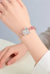 Close-up of elegant silver butterfly bracelet with pink crystal beads on wrist