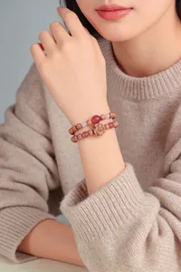 Detailed shot of double-layered cedarwood rose bracelet with strawberry crystal
