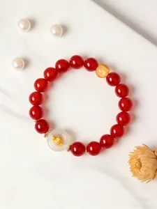 Detailed view of natural red agate bracelet featuring a white agate peace buckle pendant