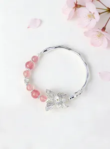 Close-up detail of silver butterfly bracelet with pink strawberry quartz beads