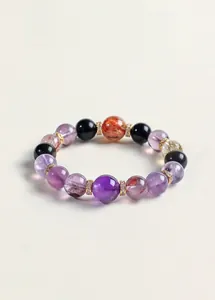 Detalle de una pulsera de piedras naturales con amatista y cuarzo rutilado elegante