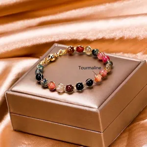 Multi-color tourmaline beaded bracelet with 14K gold wire wrap and magnetic clasp.