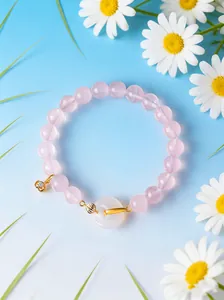 Detailed macro view of pink crystal beaded bracelet with white agate buckle and flowers
