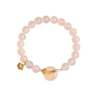 Elegant pink crystal beaded bracelet featuring a ping'an buckle and floral gold charms