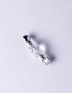 Detailed macro view of faceted clear crystal bead with minimalist silver metal accents