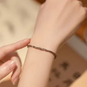 Ultra-fine 2mm silver obsidian beaded bracelet for women with 14k gold lucky bead