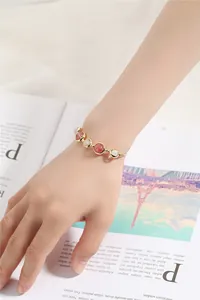 Close-up of strawberry quartz and white beads on the gold filled beaded bracelet.