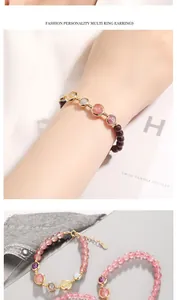 Close-up of strawberry quartz and garnet beaded bracelets with 14k gold-filled accents