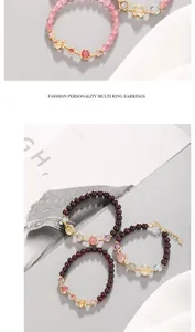 Close-up detail of multi-colored pomegranate garnet and strawberry quartz beaded bracelets