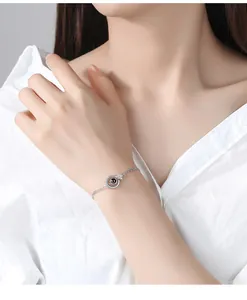 Close-up of elegant silver-plated bracelet with projection stone on woman's wrist