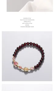 Detailed view of handmade garnet beaded bracelet with 14k gold accents and crystals