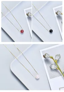Detailed view of minimalist necklaces with strawberry quartz, black stone, and rose quartz beads