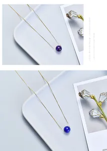 Minimalist necklace featuring vibrant purple and blue spherical crystal beads on gold chains