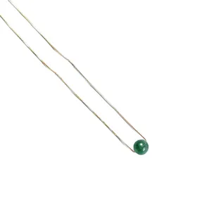 Elegant minimalist gold necklace featuring a single round green gemstone pendant on white
