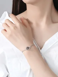 Minimalist silver projection bracelet with '100 Languages of I Love You' for women