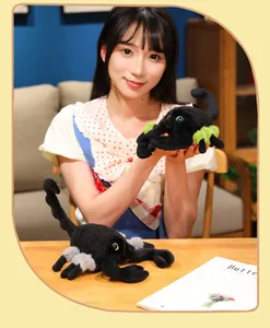 Realistic black scorpion plush toy with green accents shown with a model for scale