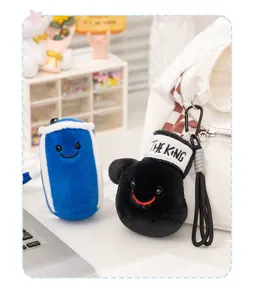 Detail of cute boxing sandbag and glove plush charms hanging on a white backpack.