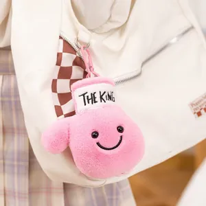 Cute pink plush boxing glove keychain featuring a smiley face and The King embroidery