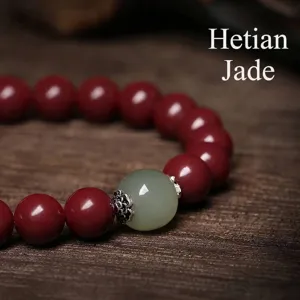 Handcrafted cinnabar beaded bracelet featuring a genuine Hetian jade focal stone