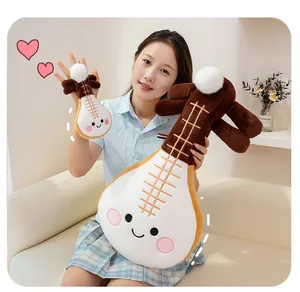Close-up detail of a cute cartoon pipa musical instrument plush toy held by a model